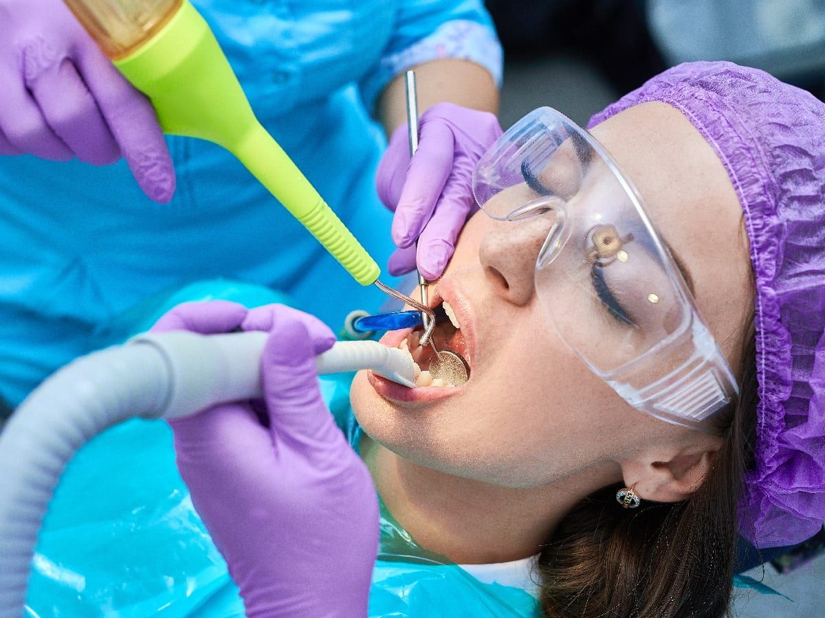 A woman undergoing air abrasion dentistry